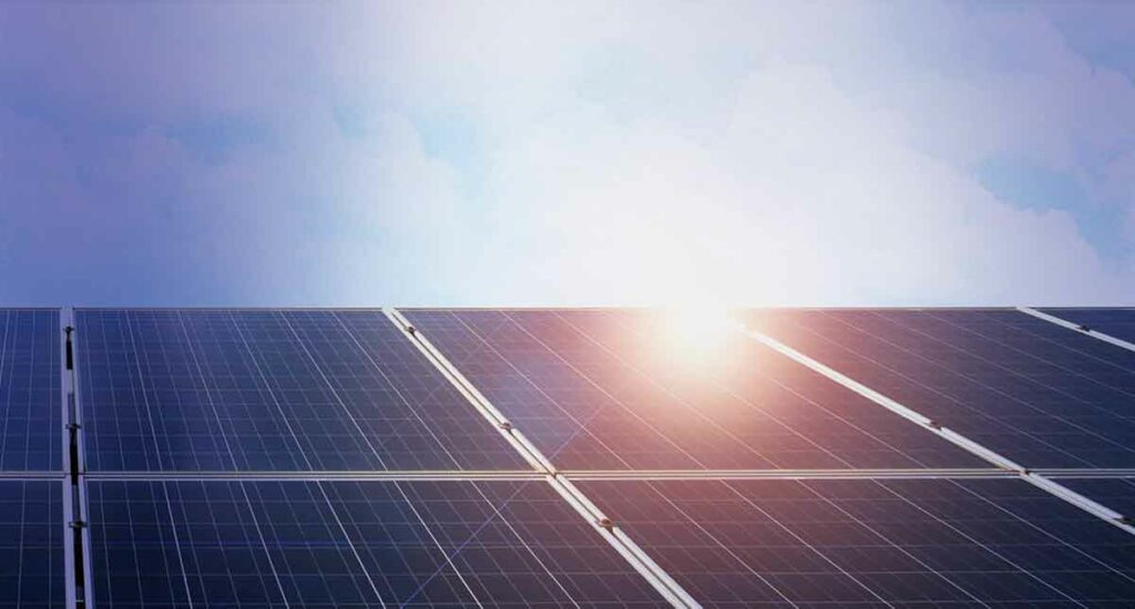 Benefits of Cleaning Solar Panels, image showing sun rising over a solar panel system