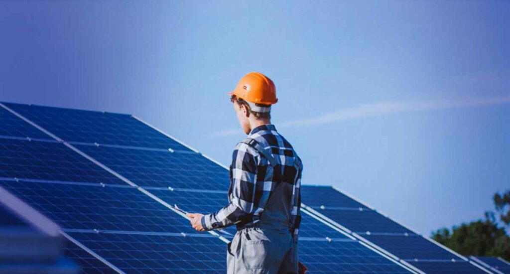 Solar Panels Cleaned by a Professional - image 1 of 2 showing a professional assessing a solar panel system