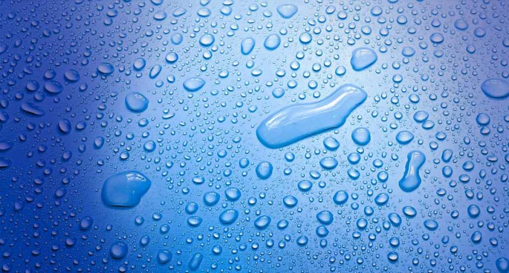Deionised Water - picture 2 of 2 of water droplets on a blue smooth background.