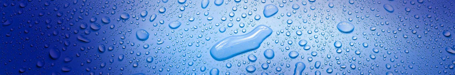 Deionised Water - picture 1 of 2 of water droplets on a blue smooth background.